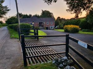 a wooden bench in front of a house at Idyllic 2 Bedroom Self-Contained UpsideDown Annexe in Llandrindod Wells