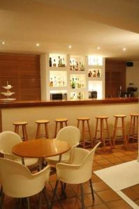 a bar with chairs and a table and a counter at Hanioti hotel in Hanioti