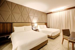 Cama ou camas em um quarto em DoubleTree by Hilton - Resort - Foz do Iguaçu