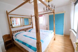 sypialnia z drewnianym łóżkiem i drewnianą podłogą w obiekcie Landjägerhaus am Südstrand - Wohnung 1 + 3 w mieście Wyk auf Föhr