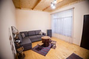 a living room with a couch and a table at Stepsa Guest House in Lermontovo