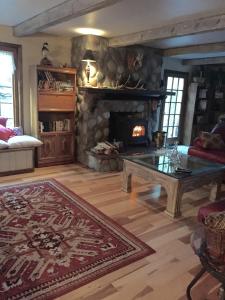 a living room with a table and a fireplace at Colorado Bed & Breakfast with beautiful views in Evergreen