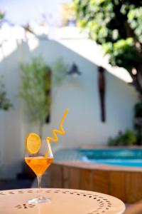 a glass of orange juice sitting on a table at Ami Vine House in Cape Town