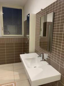 a bathroom with a sink and a mirror at Gilda e Vesuvio in Bergamo