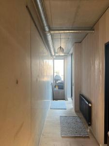 a hallway leading to a living room with a fireplace at Large house in New York style with a private rooftop terrace. in Copenhagen