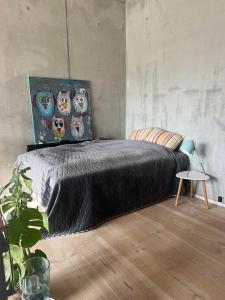 a bedroom with a black bed with owl pillows at Large house in New York style with a private rooftop terrace. in Copenhagen