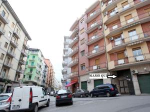 a street with cars parked in front of a building at Margherita 2.0 in Cosenza