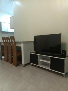 a flat screen tv sitting on top of a entertainment center at MANOVA BOUTIQUE HOTEL KIGALI in Kigali