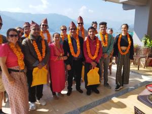 a group of people are posing for a picture at Beli Guest House in Pokhara