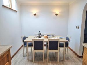 a dining room with a table and chairs at Tregurrian Villas in Newquay