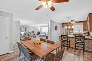 a dining room and kitchen with a table and chairs at Modern 3BR Home w Grill, Hot tub, close to Strip in Las Vegas