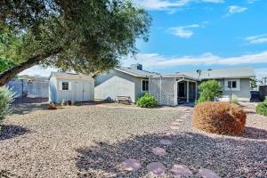 a house with a gravel yard in front of it at Modern 3BR Home w Grill, Hot tub, close to Strip in Las Vegas