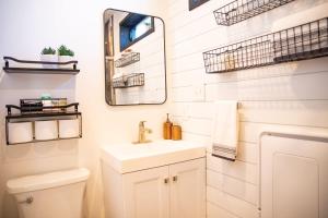 a bathroom with a sink and a mirror at New Moonlight Ridge-Shipping Container Home in Alpine