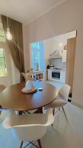 a dining room table and chairs in a kitchen at Apartment with spacious terrace Villa Floramy in Opatija +23 photos