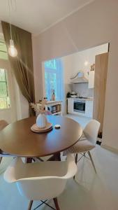 a dining room table and chairs in a kitchen at Apartment with spacious terrace Villa Floramy in Opatija