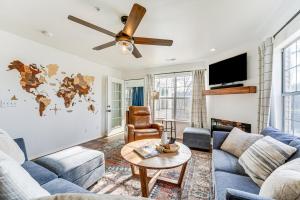 a living room with a couch and a table at Branson Lakefront Condo with Sunroom and Lake Views! in Branson