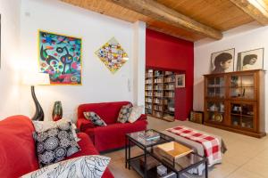 a living room with a red couch and a table at La Mariposa B&B in San Basile