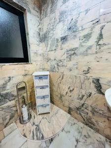 a bathroom with a sink and a marble wall at XL Seafront Home in Sliema in Sliema