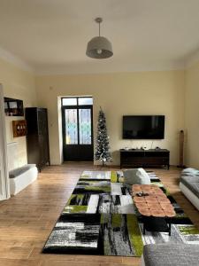 a living room with a christmas tree in the corner at DANA GUEST HOUSE in Sremski Karlovci