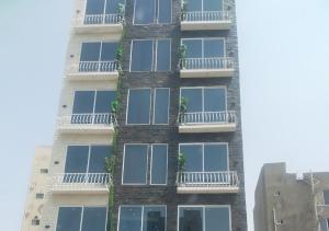 a tall building with balconies and plants on it at Bahria Prime Apartments in Lahore