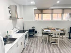 a kitchen with a table and a dining room at Scarborough New 2-Bedroom Basement in Toronto