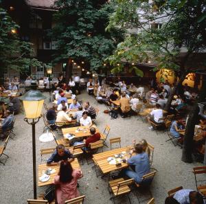 a group of people sitting at tables in a restaurant at Schlossquadrat Apartment 12 in Vienna