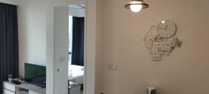 a clock on a wall next to a bedroom at The Robertson Bukit Bintang by Wowhome in Kuala Lumpur