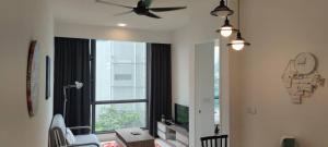 a living room with a ceiling fan and a large window at The Robertson Bukit Bintang by Wowhome in Kuala Lumpur