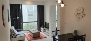 a living room with a table and a dining room at The Robertson Bukit Bintang by Wowhome in Kuala Lumpur