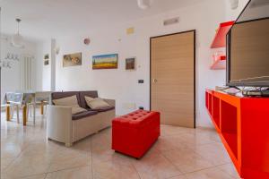 a living room with a couch and a red cabinet at Casetta : Polignano in Polignano a Mare