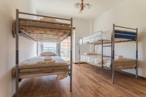 two bunk beds in a room with a window at Best Houses 02 - Brand New, Modern & Cozy - Steps From The Beach in Consolacao