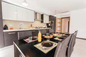 a kitchen with a dining room table with chairs at Best Houses 02 - Brand New, Modern & Cozy - Steps From The Beach in Consolacao +18 photos