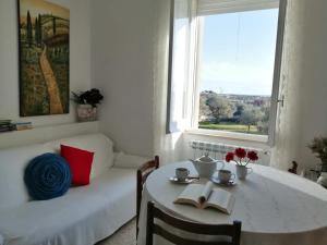 a living room with a table and a couch and a window at Welcome to Alberobello in Alberobello