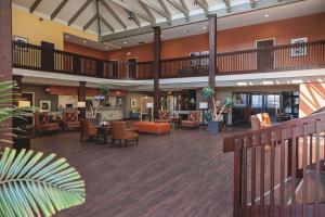 an empty lobby of a hospital with tables and chairs at Heritage Inn & Suites Ridgecrest - China Lake in Ridgecrest