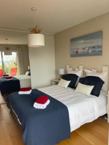 a bedroom with two beds with blue and white at Brest and Breakfast vue mer in Brest