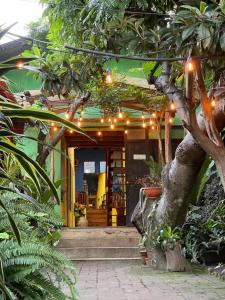 a house with a porch with lights on it at Posada Maná in San Juan La Laguna