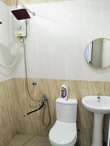 a bathroom with a toilet and a sink at Kyrina Homestay in Kuala Terengganu +18 photos