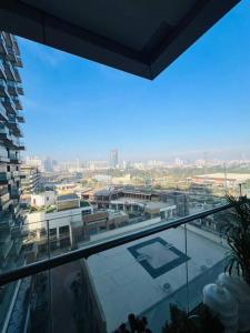 a view of a city from a glass balcony at Luxury Studios Key 10 in Gurgaon