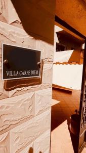 a sign for a villa carride dealer on a wall at Luxury suite in Ben Slimane