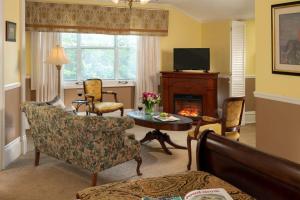 a living room with a couch and a fireplace at Albemarle Inn - Asheville in Asheville