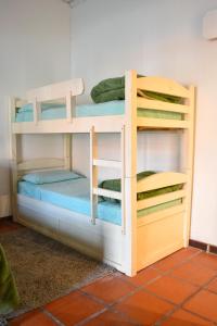 two bunk beds in a room at Posada Santa Rita in Colonia del Sacramento