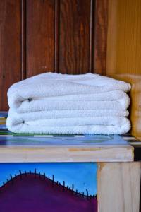 a stack of white towels sitting on a table at Posada Santa Rita in Colonia del Sacramento +91 photos