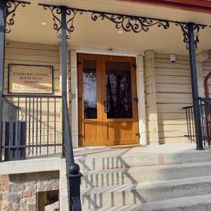 a front door of a house with a sign on it at S Neries 19 apartamentai su parkingu in Šiauliai