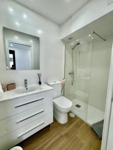 a white bathroom with a toilet and a shower at Amazing Seaside Studio by EaW Homes in Marbella