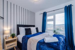 a bedroom with a bed and a window at Stylish House in Stalybridge with WiFi & Parking Sleeps 8 by PureStay in Stalybridge