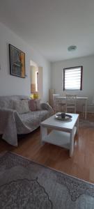 a living room with a couch and a coffee table at Apartman Milic in Soko Banja
