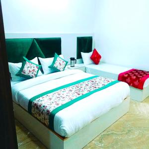 a bedroom with a large bed with colorful pillows at Hotel Diamond Stay, Nizamuddin Railway Station in New Delhi