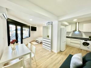 a kitchen and living room with a white table and chairs at Amazing Seaside Studio by EaW Homes in Marbella +9 photos