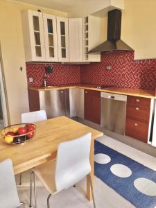 a kitchen with a wooden table and a bowl of fruit at Apartment in private villa in Gryta