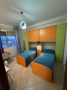 twee bedden in een kamer met groen en oranje bij 3 Bedrooms Apartment in Shkodër